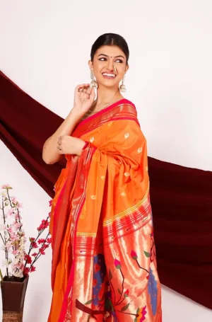 Orange handloom pure silk Paithani saree with gold zari border and traditional handwoven motifs, worn by woman