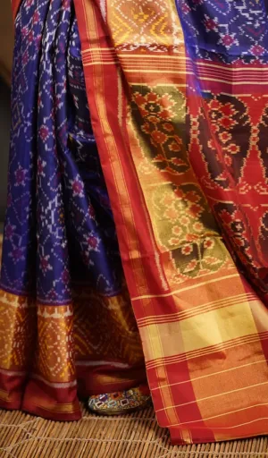 Mulberry silk handcrafted single ikat Patola saree in blue with red and gold woven border and traditional motifs