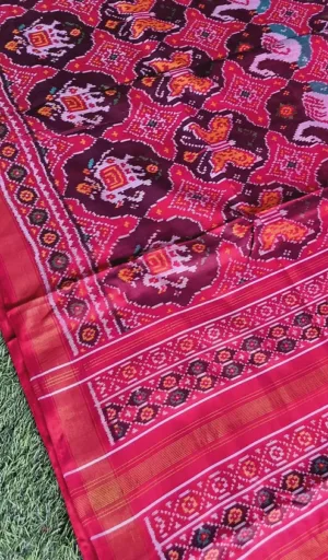 Mulberry silk handcrafted single ikat Patola saree in maroon and pink with traditional geometric motifs