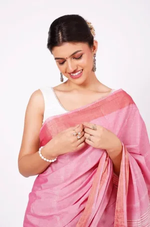 Soft pink handloom pure cotton Paithani saree with subtle zari border, worn by woman in elegant traditional style