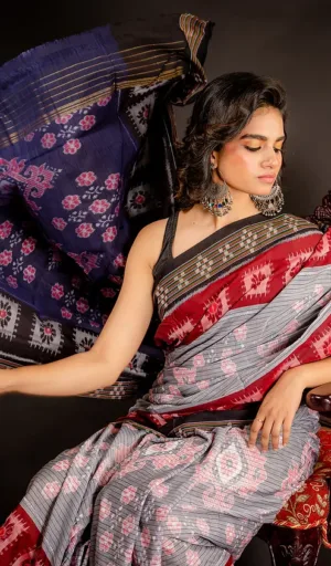 Woman wearing grey handloom Odisha ikat cotton saree with red and black traditional woven motifs