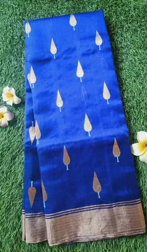Blue Chanderi saree with gold leaf motifs and a contrasting border, displayed flat on a textured surface.