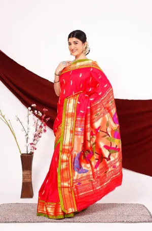 Red handloom pure silk Paithani saree with gold zari border and multicolour traditional motifs, worn by woman