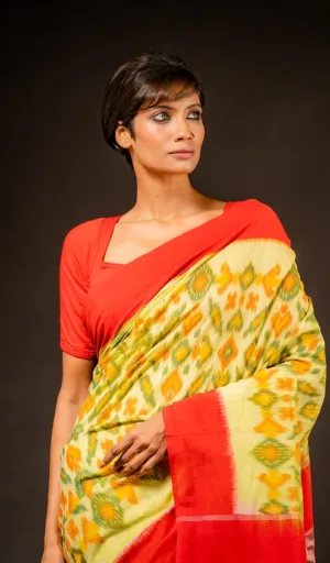 Woman wearing single ikat pure cotton saree in yellow and green with red contrast border