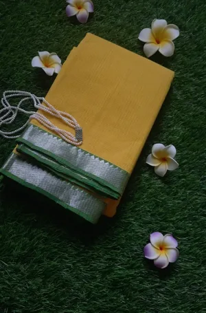 Yellow handloom pure cotton Mangalagiri saree with green border, worn by woman in traditional style